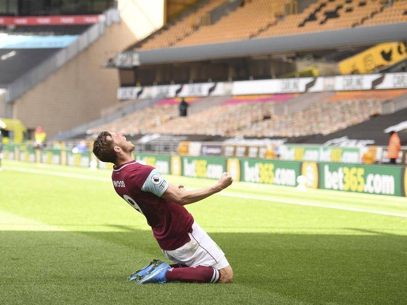 Burnley's Chris Wood celebrates his hat-trick for Burnley against Wolves in the Premier League.