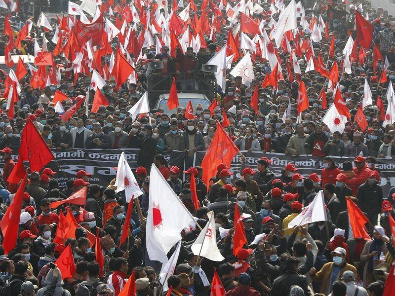 Tens of thousands of people protested in Kathmandu against the PM dissolving Nepal's parliament.