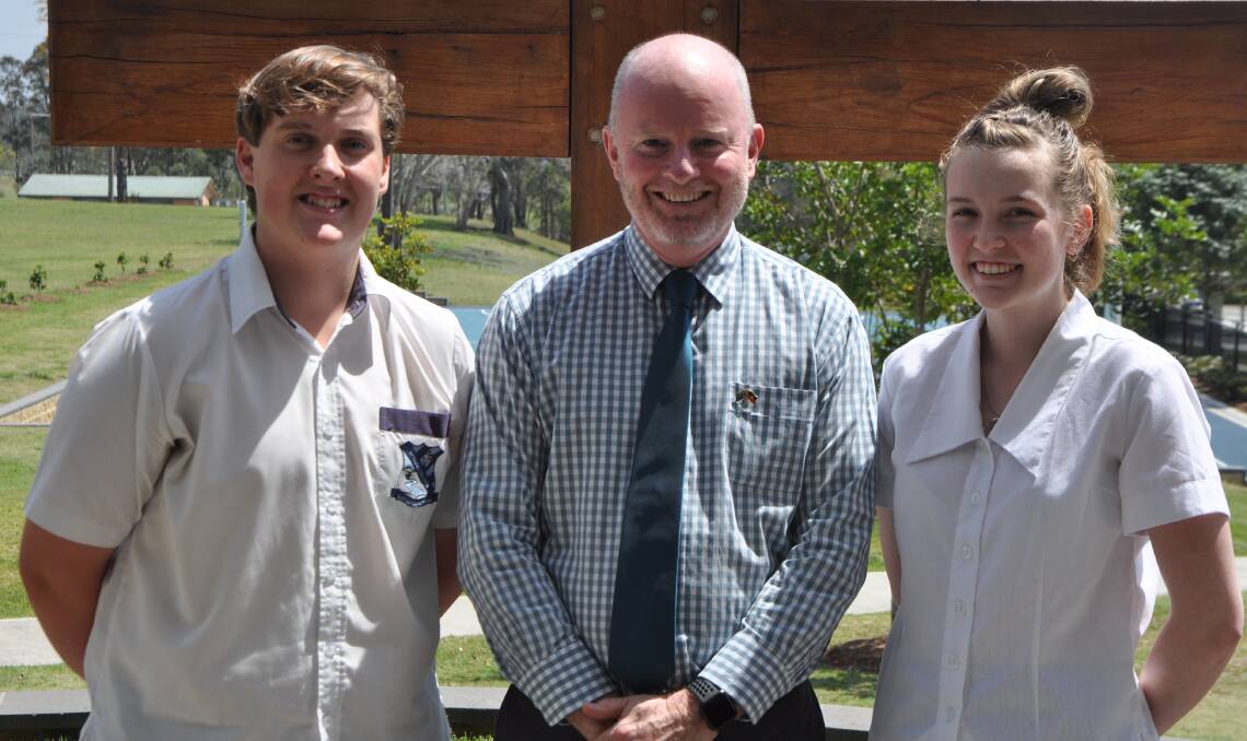 Pat Brennan with St Paul's College principal Mr Lewis and Calissa Percival. Photo: Stephen Katte 