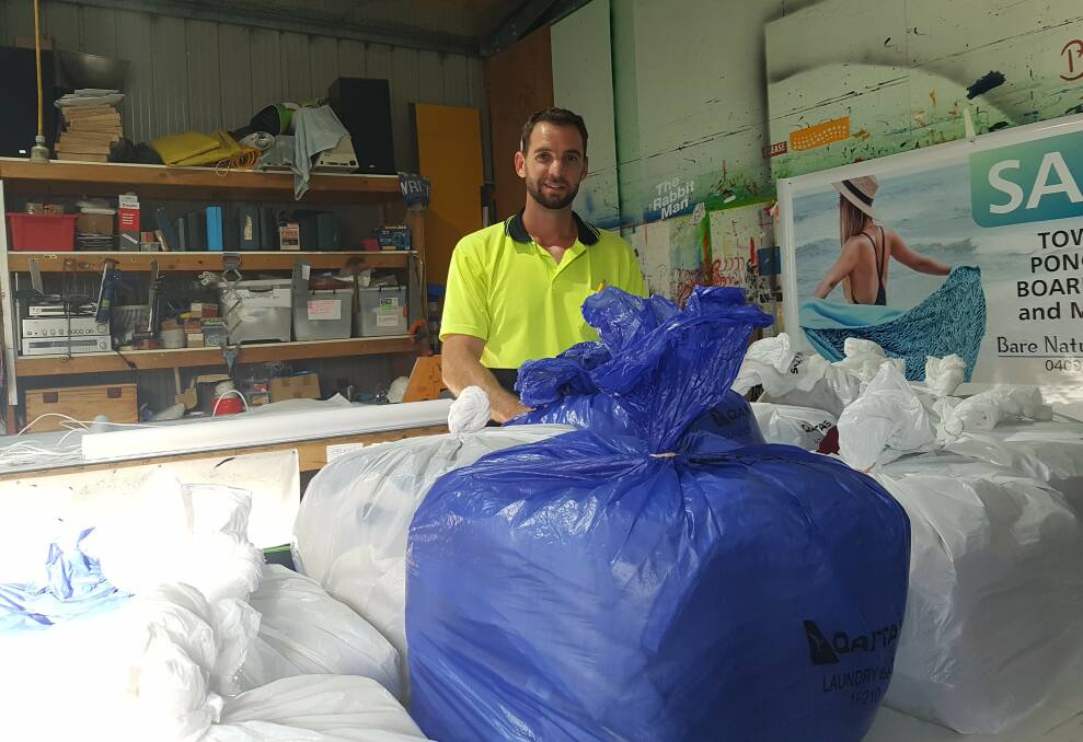 Kempsey West Rotary Club member Brett Stringer with some of the blankets. Photo: Supplied 