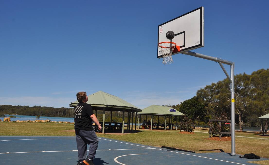 RJ has been practicing his basketball skills on the new court since it opened. Photo: Stephen Katte 