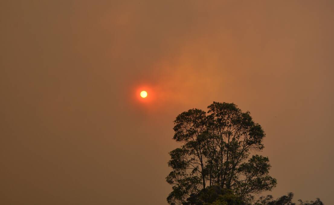 The sun was barley visible through all the smoke and ash 