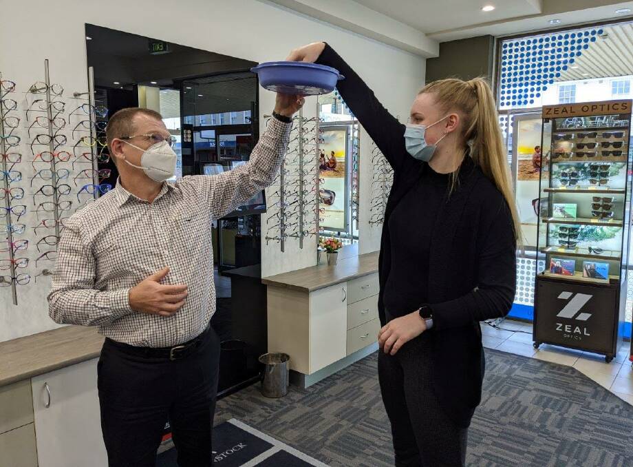 KTC President Ben Bailey and trainee dispenser Olivia drawing the raffle at Masons Eye Care centre. Photo: Supplied 