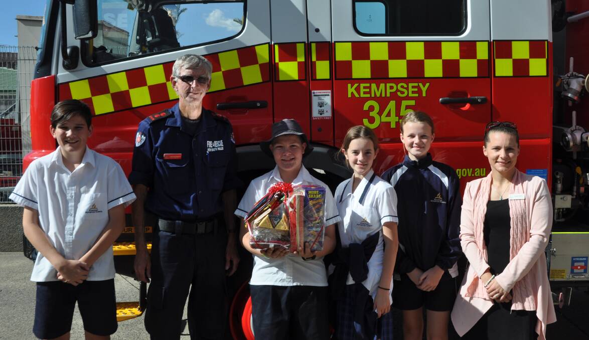 Kempsey Adventist School students with their teacher, Kastle Mainey and Station Commander Tony Hackenberg. Photo: Stephen Katte 