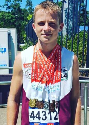 HEAVY: Carson Hudson weighed down by all his medals. Photo: Supplied 