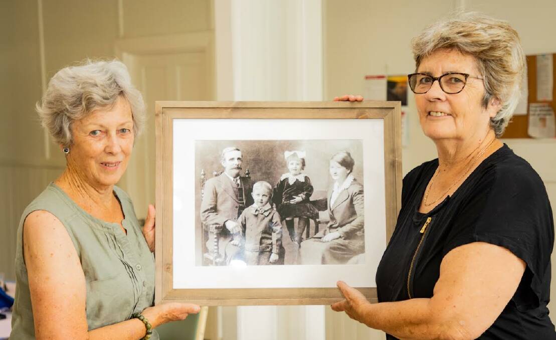 President Dianne Gulson (left) and vice president Rachel Burns (right) with a photo from the exhibition of Eichmann descendants. Photo: Supplied 