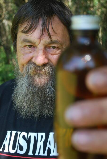 Medical Cannabis campaigner Tony Bower holding one of the bottles with tinctures that contain medicinal marijuana 
