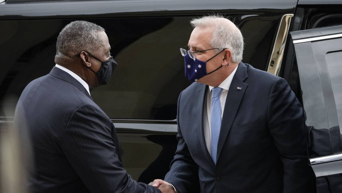 Australian Prime Minister Scott Morrison (right) shakes hands with US Defense Secretary Lloyd Austin. Picture: Getty Images