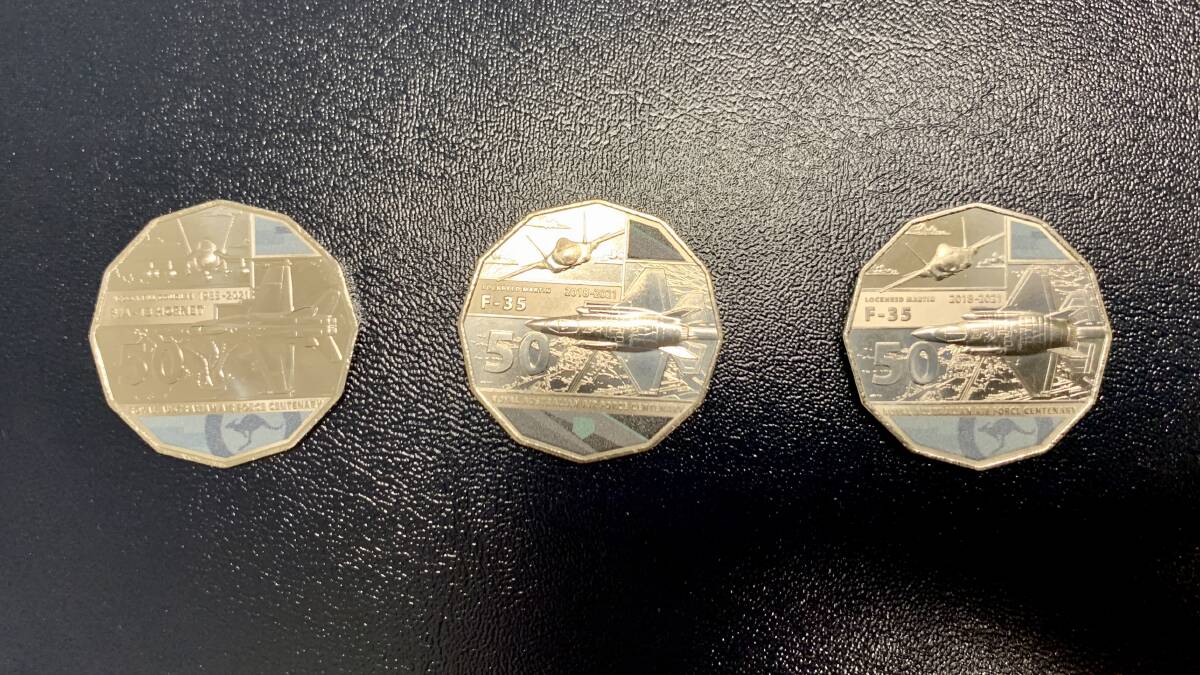 FIND THE MISPRINT: Left to right, F/A-18 Hornet coin, F-35 Joint Strike Fighter coin and the coin that incorrectly contains elements of the first two.