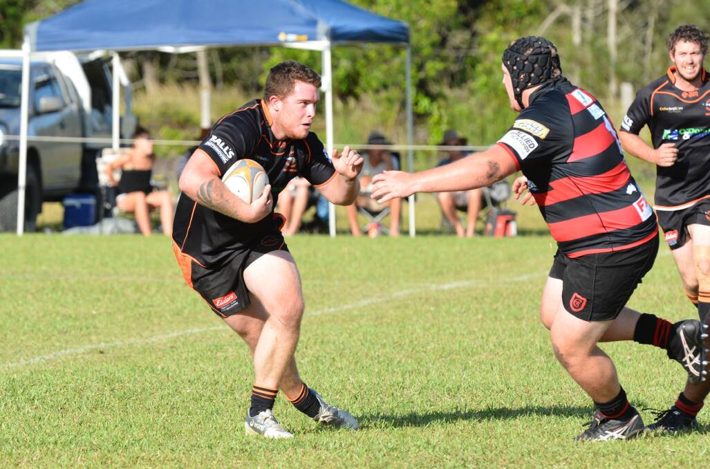 Footwork: Kempsey Cannonballs' Nathan Phillips carries the ball forward against the Coffs Harbour Snappers. Photo: Penny Tamblyn.