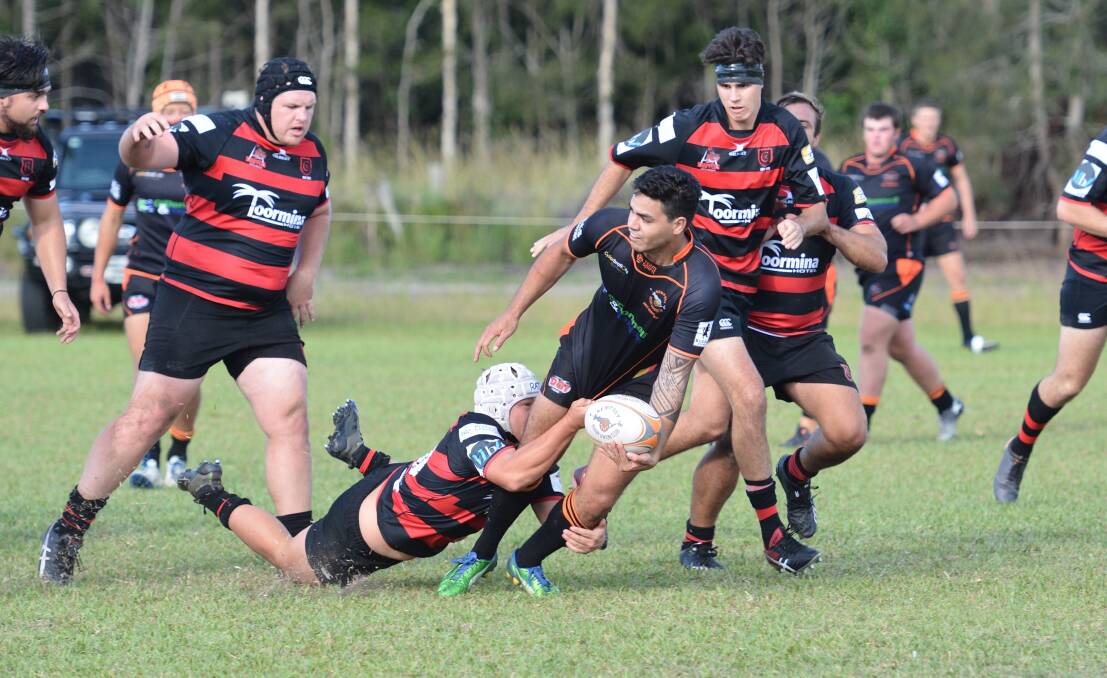 Looking for support: Kempsey Cannonballs outside back Iulio Tavete offloads the ball in their season opener against the Coffs Harbour Snappers. Photo: Penny Tamblyn.