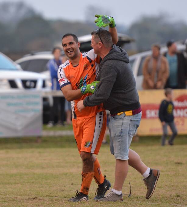 Jubilation: Rangers goalkeeper John Clancy his congratulated by a friend after he saved the penalty to send his side to the grand final. Photo: Penny Tamblyn.