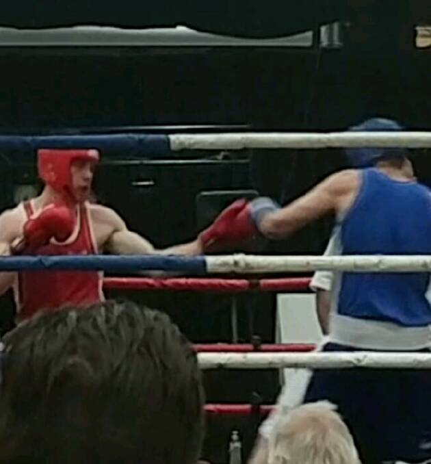 Jordan Lennon (red) throws a left against his opponent Ben Ramjam.
