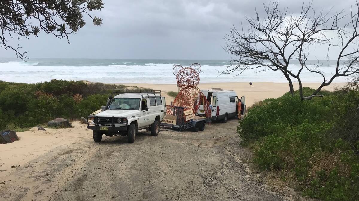 Freedom: Marcus Skipper uses his vehicle to tow the trailer, carrying the sculpture bear, out of the sand. Photo: Supplied.
