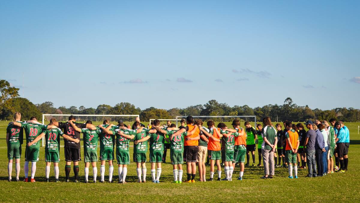 Kempsey Saints and Wallis Lakes football clubs stand in a minutes silence for Catherine May Clarke prior to their first grade match.