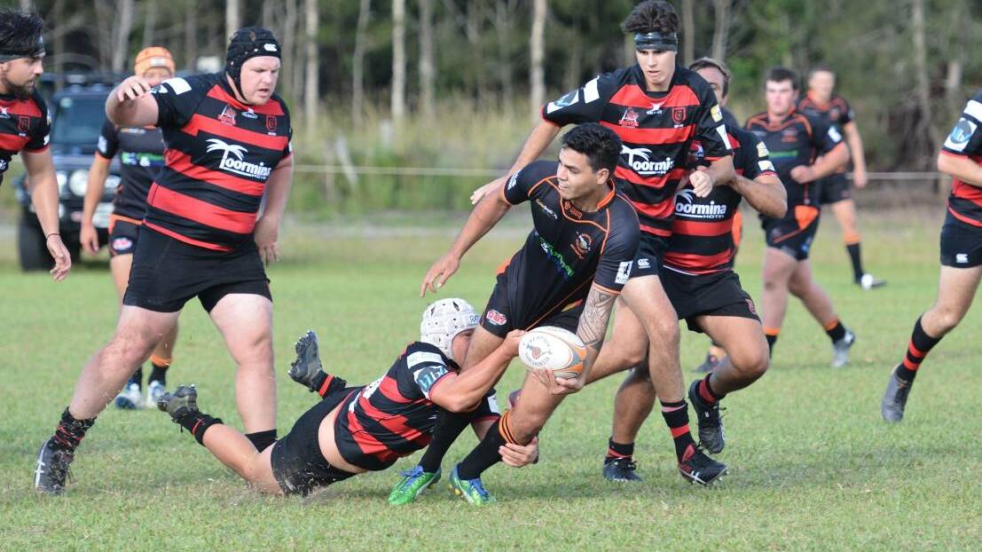  Looking for support: Kempsey Cannonballs outside back Iulio Tavete offloads the ball in their season opener against the Coffs Harbour Snappers. Photo: Penny Tamblyn.