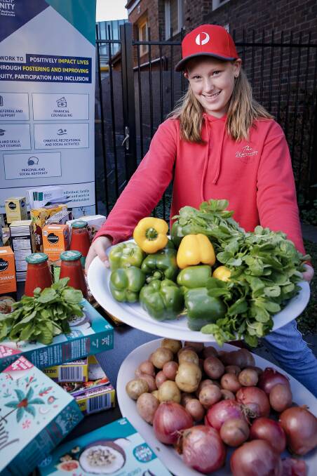 Twelve-year-old Audrey providing fresh food and groceries to disadvantaged community members. Photo: Supplied