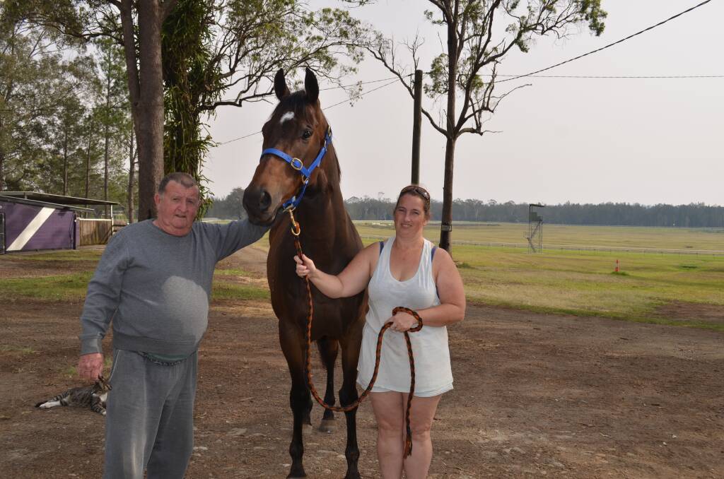 Horse trainer Barry Ratcliff and strapper Natalie Roxbourgh with First Time Lucky. Photo: Callum McGregor