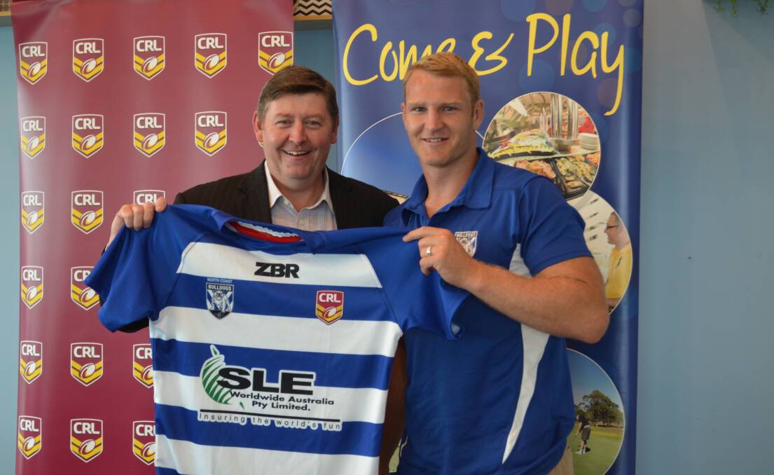 South West Rocks Country Club CEO David Cunningham and Hat Head product and Bulldogs prop Aiden Tolman hold up the 2019 North Coast Bulldogs jersey. Photo: Callum McGregor.