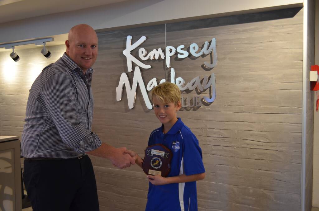 Kempsey Macleay RSL Club's CEO Daniel Abela presents Bailey Kane the sportsperson of the month award.