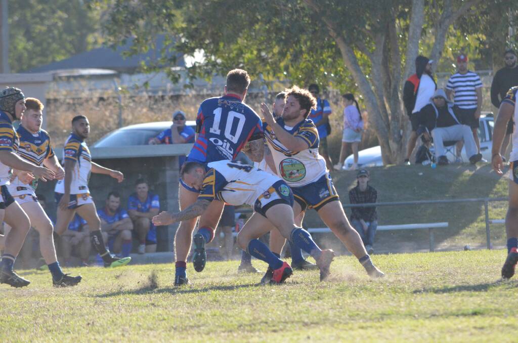 Mustangs players Chris Piper and Dre Barker tackle a Wauchope prop in round 13.