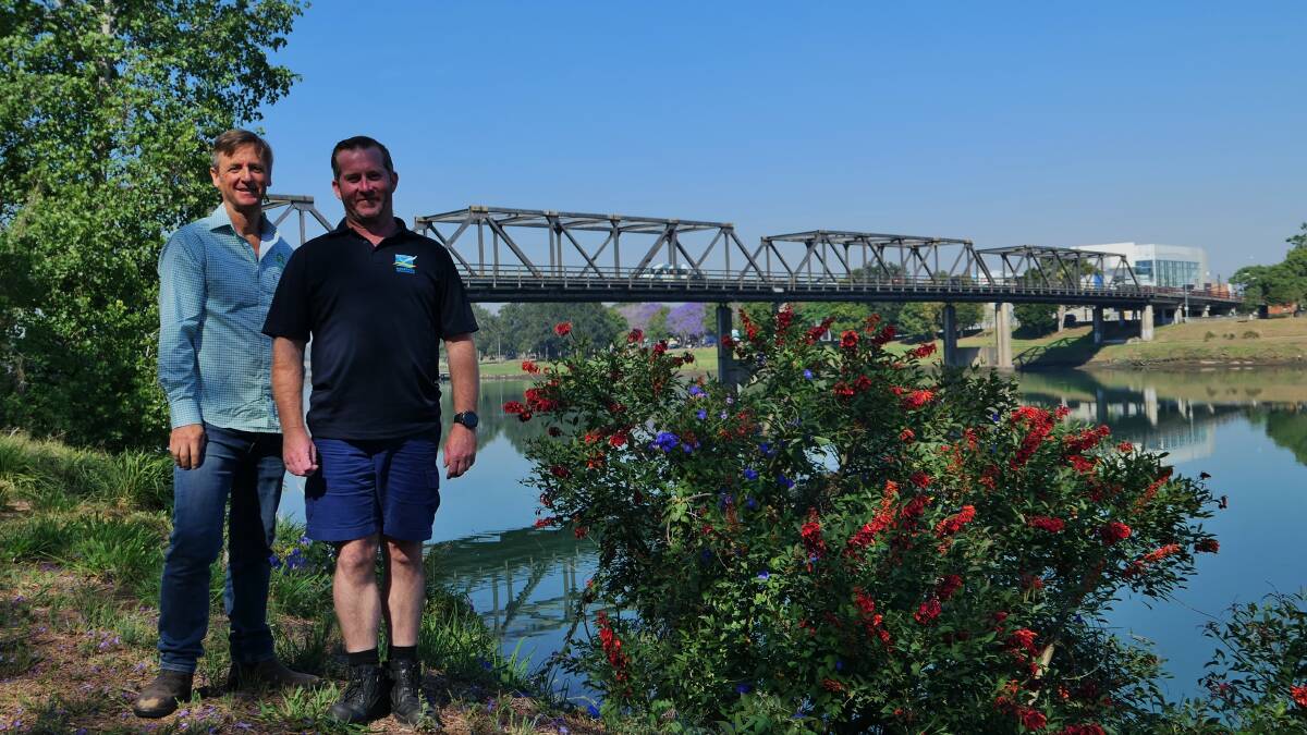 Landcare Officer Andy Vinter and Weed Officer Greg Egan with a Cockspur Coral Tree in Kempsey. Photo: supplied
