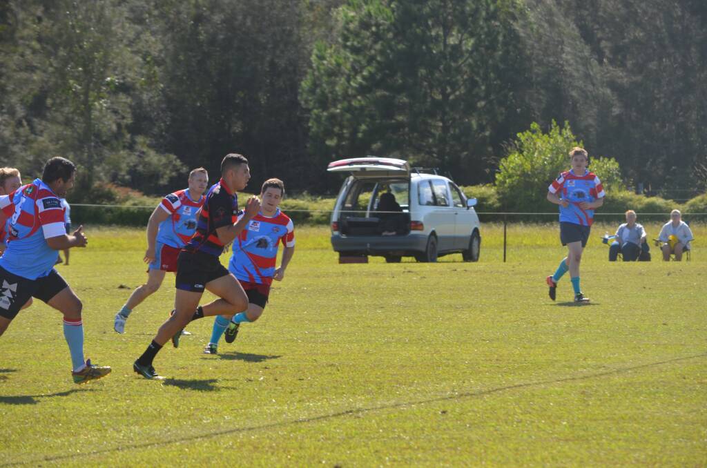 Too fast: Triston Reilly breaks away from would-be defenders at the Crescent Head Rugby Sevens tournament. Photo: Callum McGregor.
