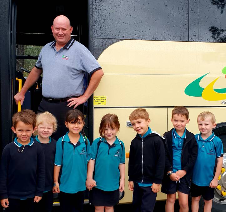 Adrian Cooper from Cavanagh’s Bus Service with Aldavilla Primary School students.