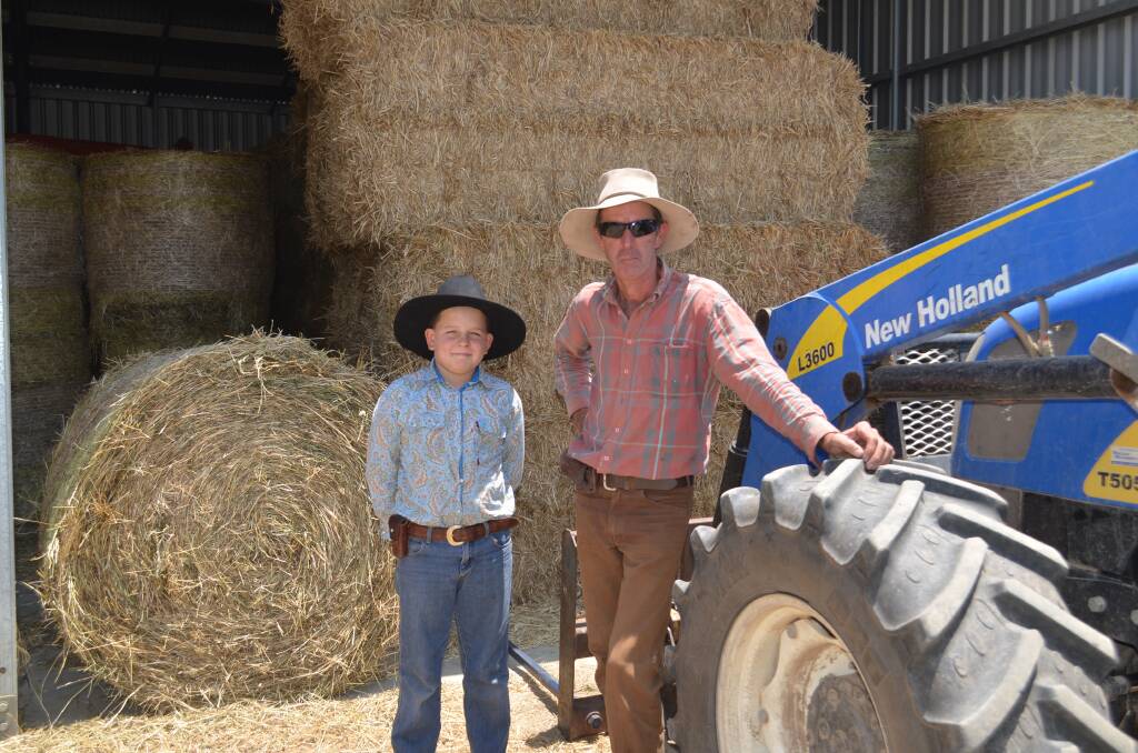 11-year-old Charlie with his father and fifth generation Macleay farmer David O'Neill. Photo: Callum McGregor