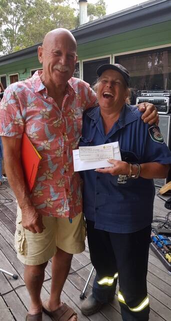  Roger 'Fergo' Ferguson presented the Crescent Head Rural Fire Service representative Jo Watts with a $5000 cheque