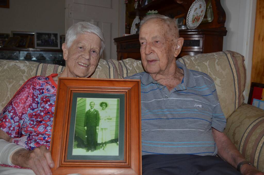 True love: Mary and Bill Kemp proudly hold up a photo taken on their wedding day, seventy years on. Photo: Callum McGregor.