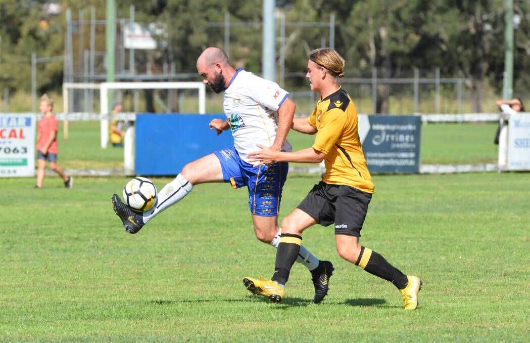 Skill: Brent Ryan controls the ball despite the presence of a Tigers defender. Photo: Penny Tamblyn.