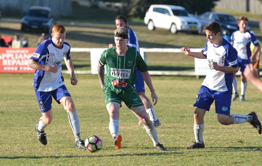 Scramble: Kempsey Saints' Troy Ward attempts to maintain possession while to Rangers players close in on him. Photo: Penny Tamblyn.