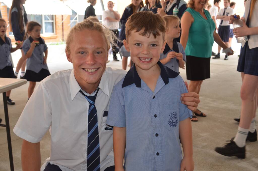 St Paul's College Year 12 student Finn with St Joseph's kindergarten student Zane