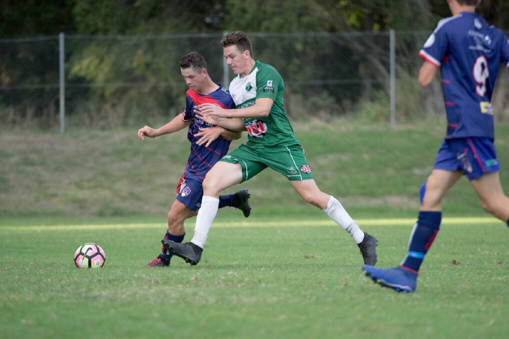 Shoulder-to-shoulder: Kempsey Saints' Jake Conomos tussles for the ball with a Wauchope player. Photo: Janayah Barnett