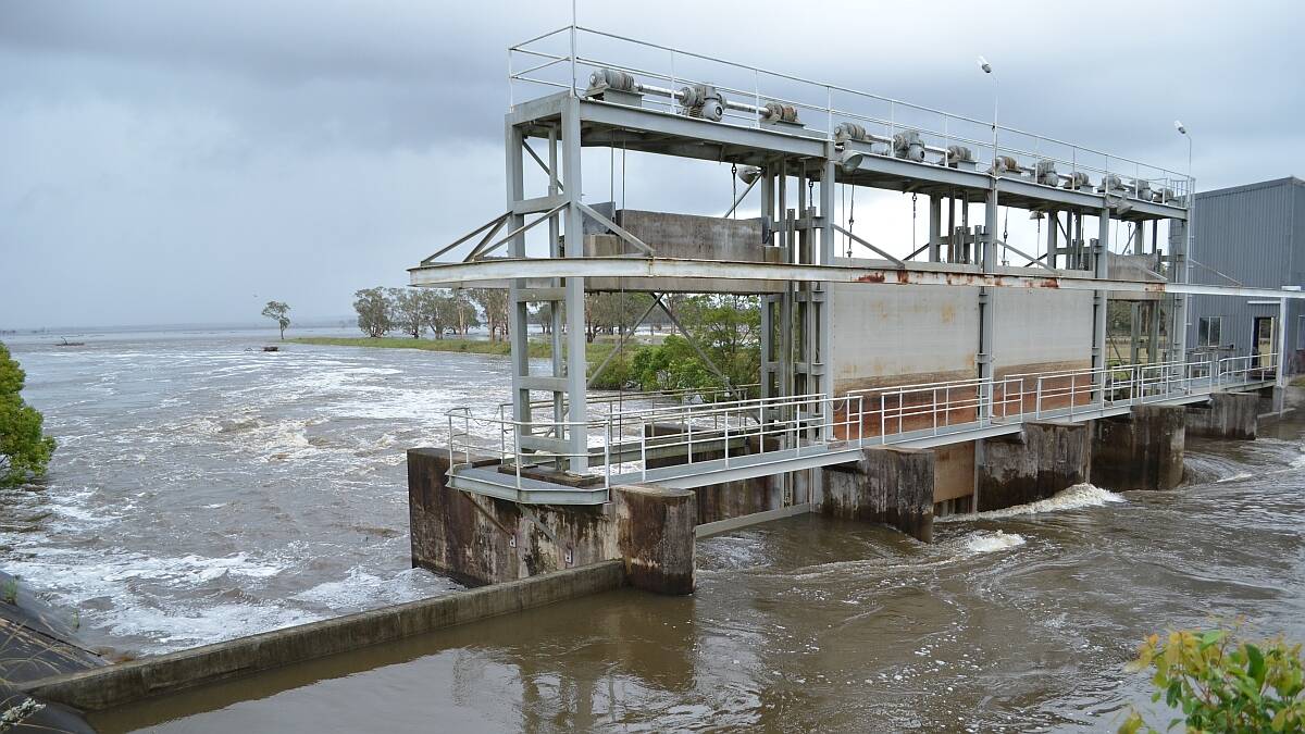 Water surges through the Belmore River floodgates on Sunday.