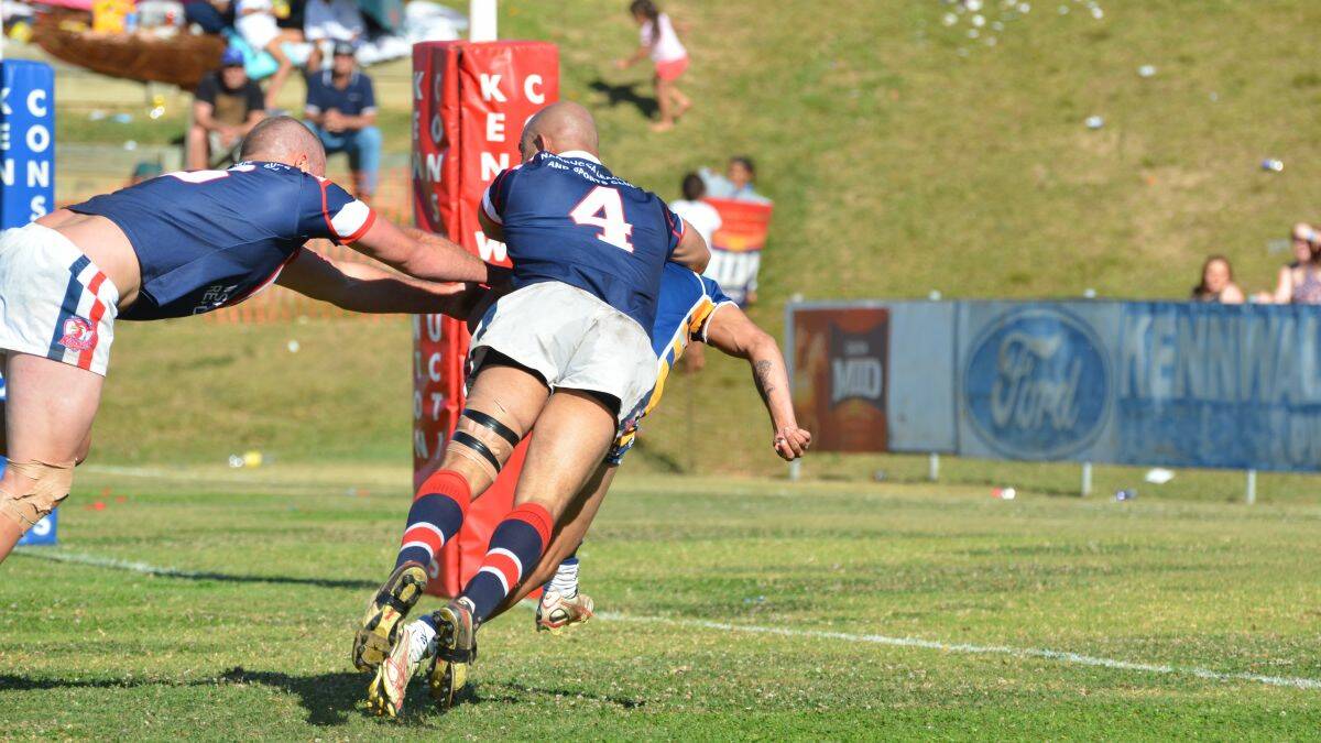 Gotcha!: A desperate Roosters defence lunges at the Mustangs hooker and looks to have cut him down...