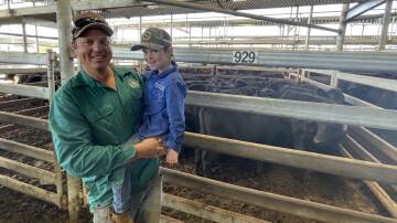 Cameron and Kip Smith, River Run, Currowan, with their 40 Angus steers, 204kg, sold for $925. 